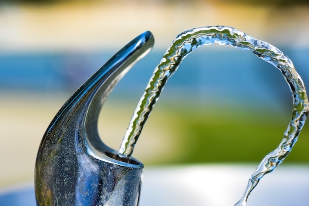 a metal outdoor water fountain