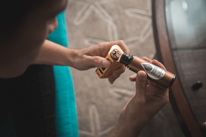 E-liquid being put into vaping device