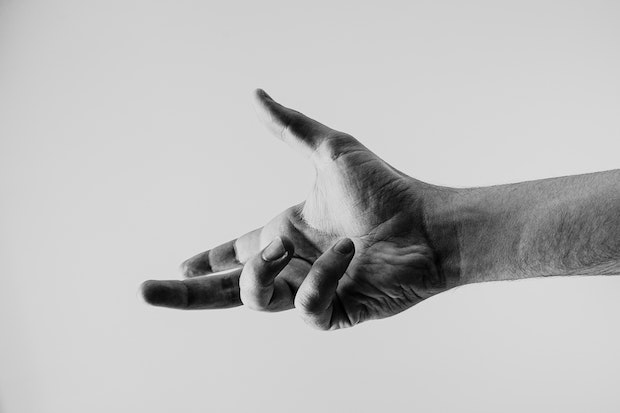 a black and white image of an outstretched hand