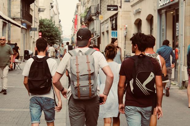 A group of young men walking down a street