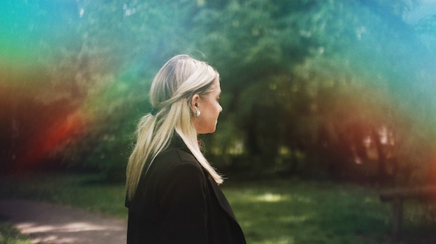 a blonde woman walking in a park