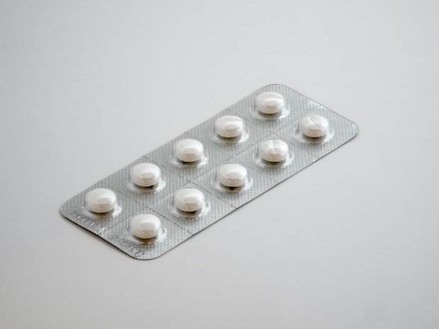 A blister pack containing white pills