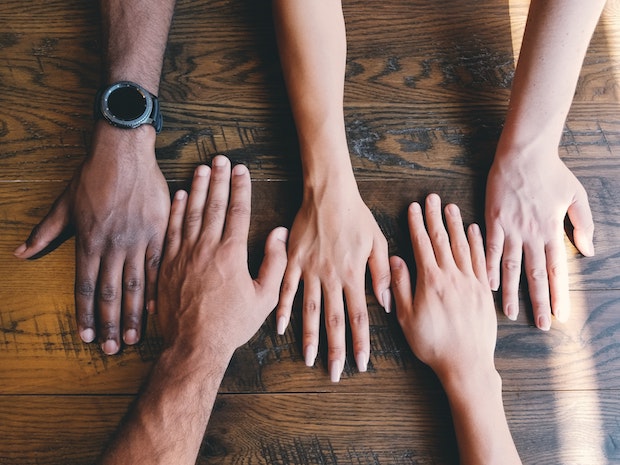 several hands lined up next to each other