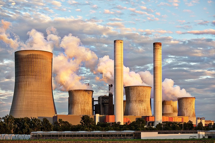 image of power plant with smoke in the air