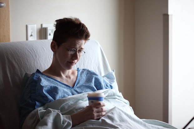 a woman lying in a hospital bed