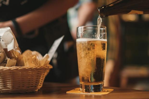 A bottle of beer being poured into a glass