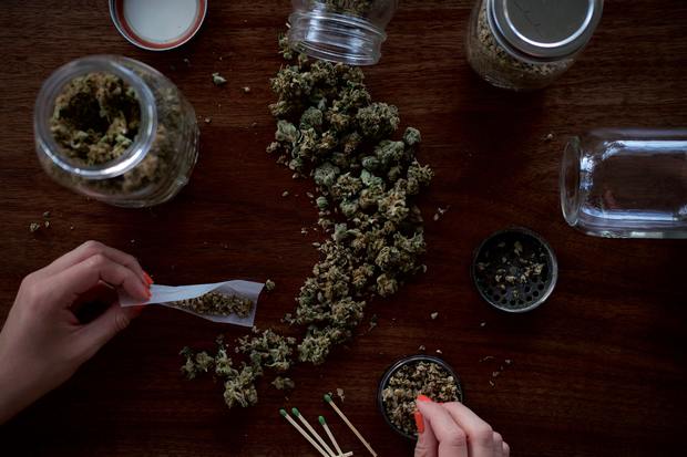 weed buds on a table and various jars